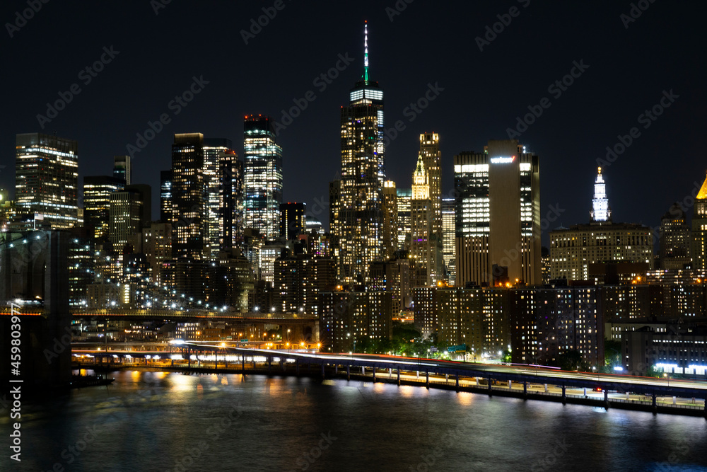 Obraz premium View of lower Manhattan and Financial district at night. Skyscrapers with lights on in New York City