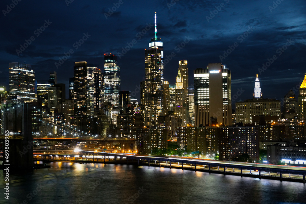 View of lower Manhattan and Financial district at night. Skyscrapers with lights on in New York City