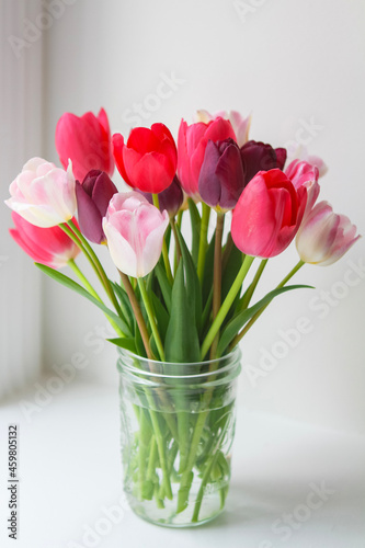 bouquet of pink tulips in mason jar