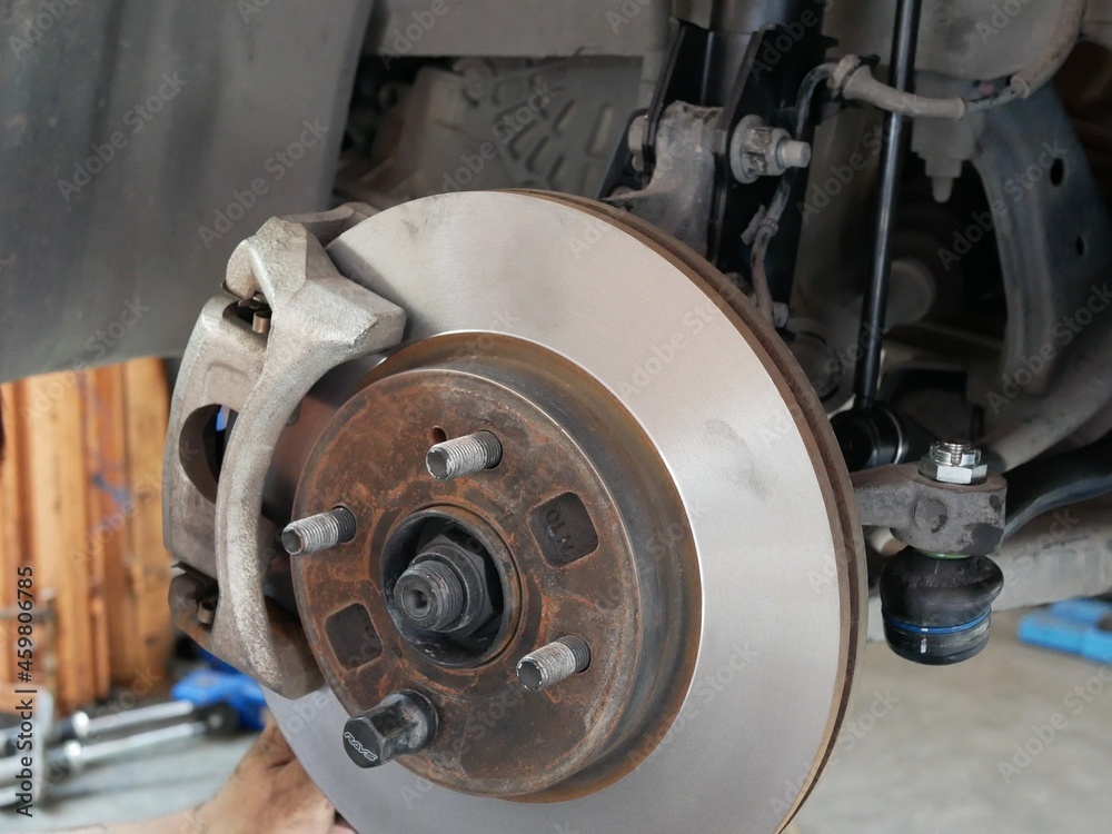 maintaining car wheel brake disc at repair service station.
maintaining car wheel brake disc at repair service station.