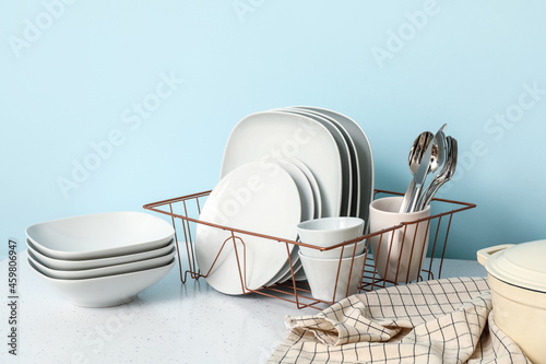 Set of clean dishes on color background