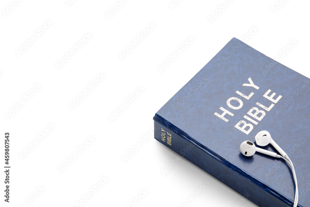 Holy Bible and earphones on white background, closeup Holy Bible and earphones on white background, closeup