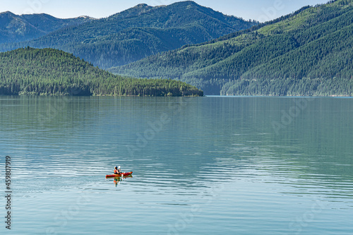 Woman kayaking alone on a lake