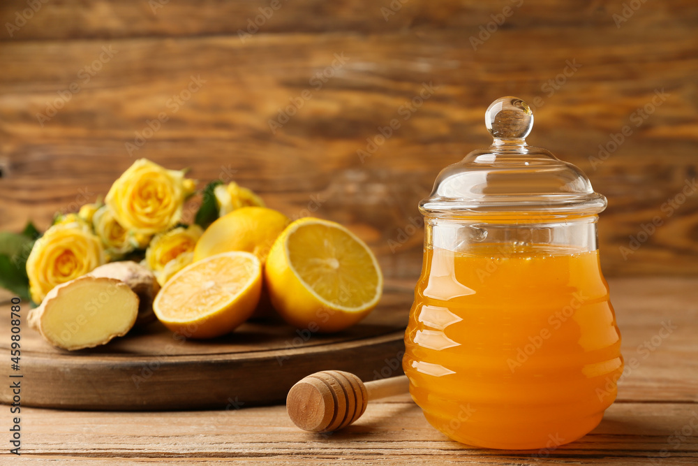 Sweet honey, ginger and lemon on wooden table Sweet honey, ginger and lemon on wooden table