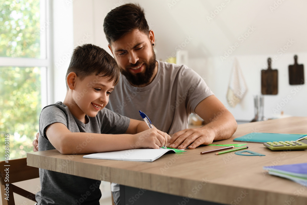 Little boy with his father doing lessons at home Little boy with his father doing lessons at home