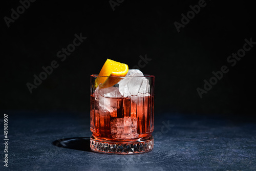 Vászonkép Glass of tasty Negroni cocktail on dark background