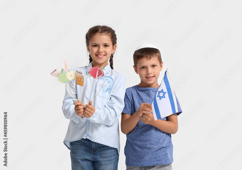 Little children with flag of Israel and decor for Rosh Hashanah (Jewish New Year) on white background Little children with flag of Israel and decor for Rosh Hashanah (Jewish New Year) on white background