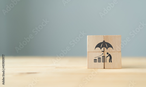 Pension insurance, senior business, life insurance and support seniors concepts for aging society. Wooden cubes with retirement assurance symbol standing on table with grey background. Banner.