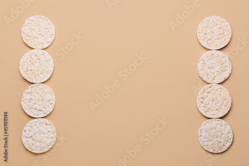 Puffed rice crackers on color background