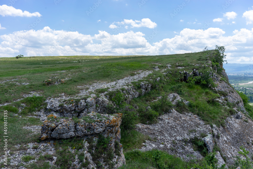Natural landscape with a green field under a blue sky Natural landscape with a green field under a blue sky