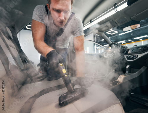Fotografía Servise specialist doing car seats dry cleaning with vapor cleaner