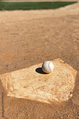 Baseball at home plate with copy space on infield dirt