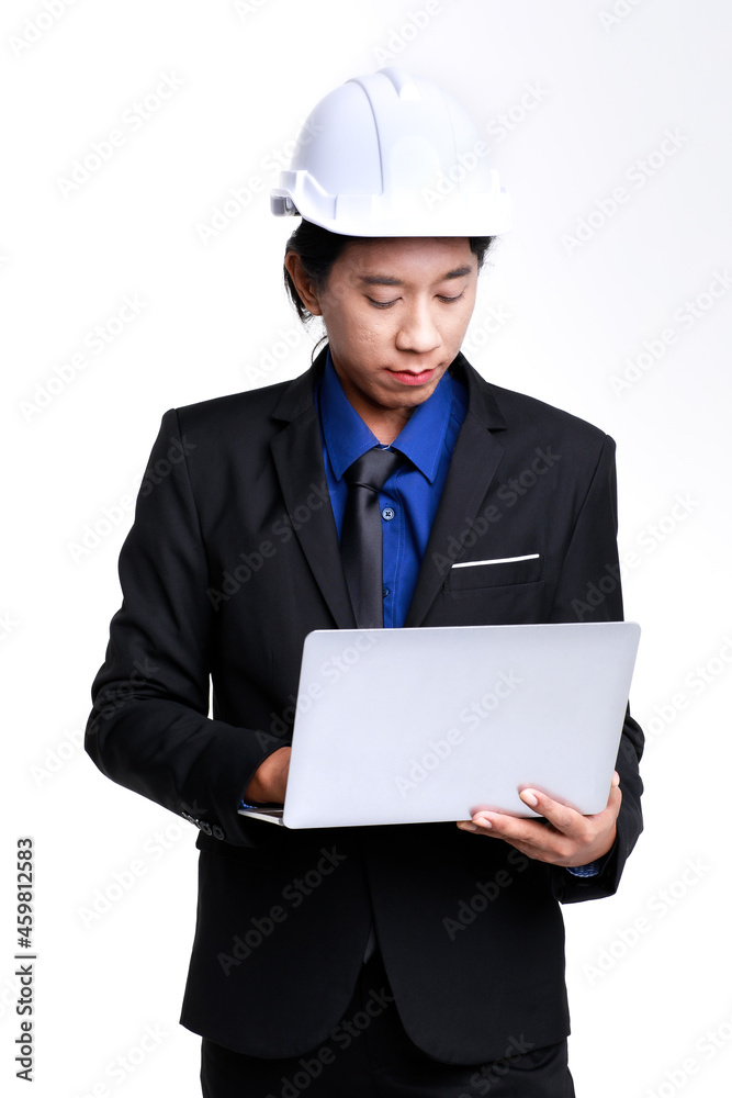 Isolated studio shot of Asian professional successful male foreman industrial engineer in black formal suit and safety helmet standing typing report on laptop notebook computer on white background Isolated studio shot of Asian professional successful male foreman industrial engineer in black formal suit and safety helmet standing typing report on laptop notebook computer on white background