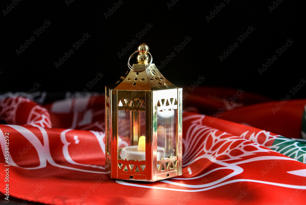 Lantern with burning candle and flag of Afghanistan on dark background Lantern with burning candle and flag of Afghanistan on dark background
