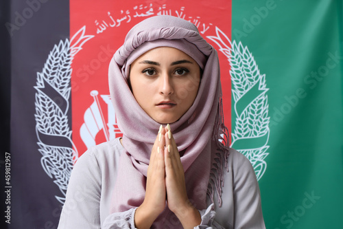 Praying Muslim woman agains...