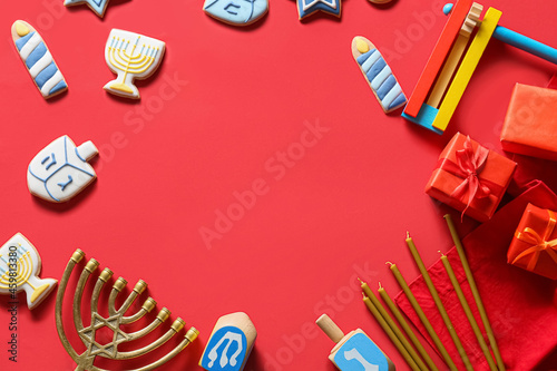 Frame made of symbols of Hanukkah on color background