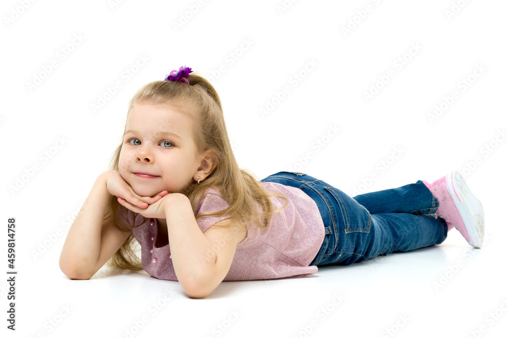 Lovely blonde little girl lying on the floor Lovely blonde little girl lying on the floor