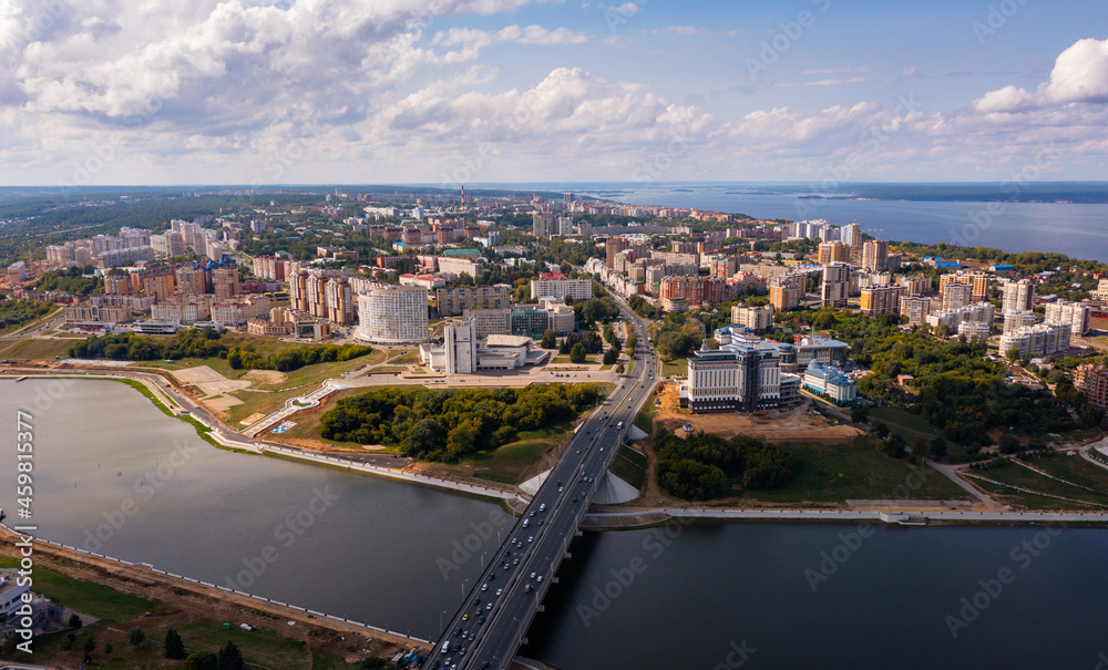 Scenic general aerial view of Cheboksary cityscape on banks of Volga River on sunny summer day, Chuvashia, Russia