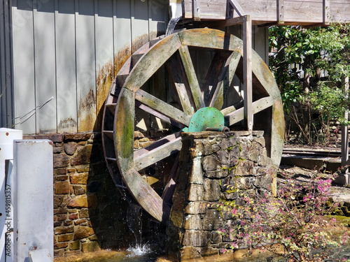 Wooden water wheel stone base splashing water