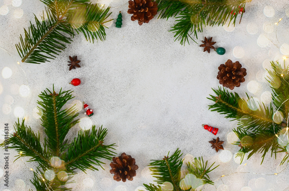christmas background or greeting frame card with copy space text with new year festive holiday decoration, small wooden toys, cones, christmas tree branch and bokeh, flatly top view christmas background or greeting frame card with copy space text with new year festive holiday decoration, small wooden toys, cones, christmas tree branch and bokeh, flatly top view