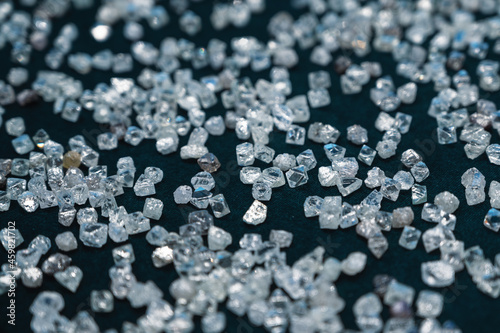 Close-up photo, a scattering of transparent diamonds on velvet