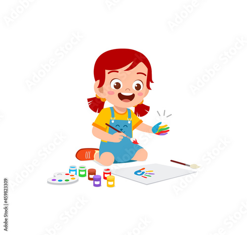 cute little boy using paint to hand for art