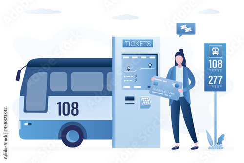 Passenger buys bus ticket through terminal. Businesswoman uses ticket machine. Self-service travel pass technology. Bus, public transport. Woman holds credit card for fare payment. photo