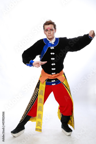 Chinese traditional warrior male costume at studio over grey background. Handsome man wearing national costume in Beijing, China