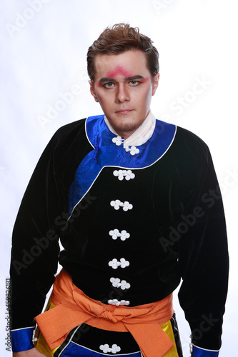 Chinese traditional warrior male costume at studio over grey background. Handsome man wearing national costume in Beijing, China