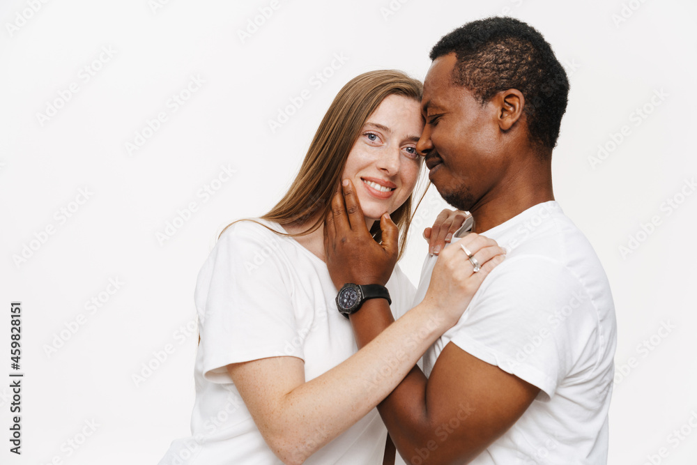 Smiling mid aged diverse casual couple embracing Smiling mid aged diverse casual couple embracing