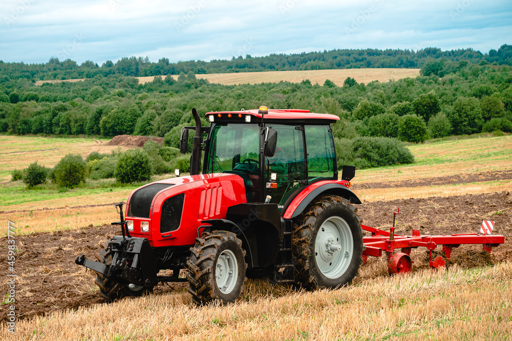 Farmer in tractor plowing the land in autumn Farmer in tractor plowing the land in autumn