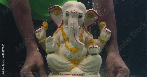 Lord Ganesh idol immersion in water during Indian festival Ganesha Chaturthi. photo