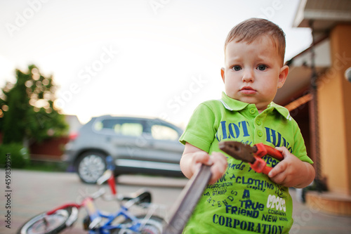 Boy repair bike. Little mechanic work with bicycle.