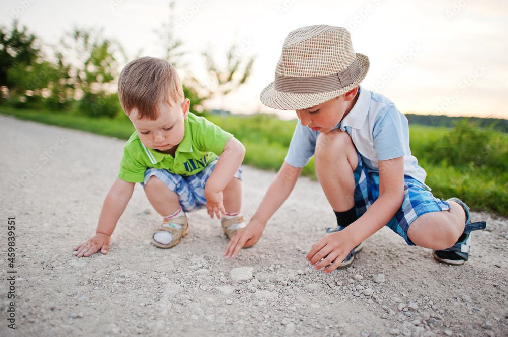 Two brothers playing on village road. Two brothers playing on village road.