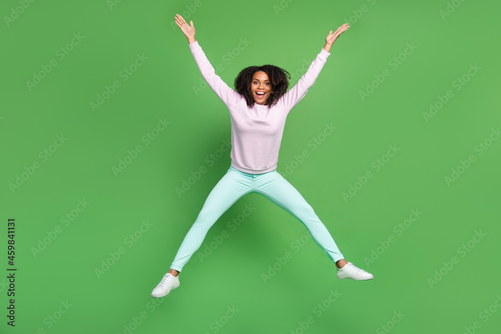 Full length photo of funny millennial brunette lady jump wear pullover pants shoes isolated on blue background Full length photo of funny millennial brunette lady jump wear pullover pants shoes isolated on blue background