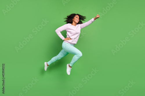 Full size profile photo of cool millennial brunette lady run wear pullover pants shoes isolated on blue background