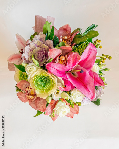 various colorful flowers bouquet top view closeup on white background