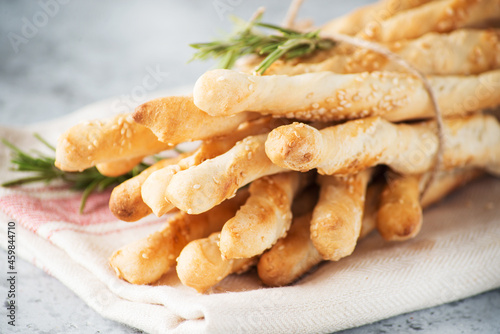 Italian grissini breadsticks with herbs and sesame seeds, selective focus