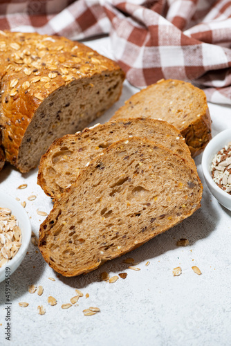 fresh bread with oatmeal and seeds, vertical