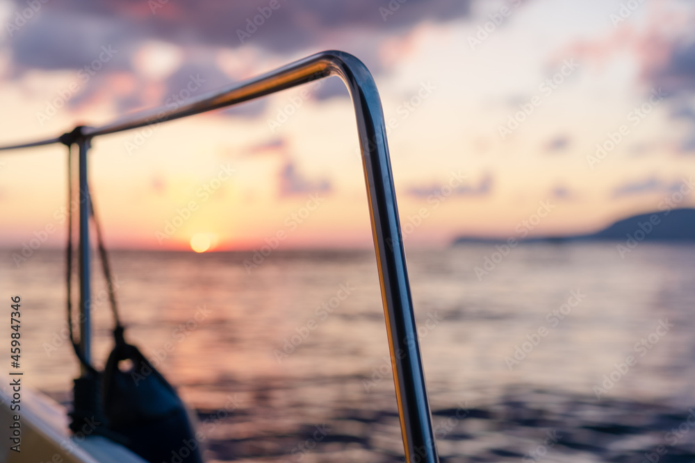 Deck of white yacht sailing in open sea at sunset Deck of white yacht sailing in open sea at sunset