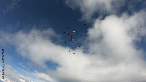Formation skydiving. A group of skydivers is training in the sky.