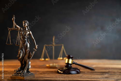 Lawyer office. Law symbols composition: judge’s gavel, Themis sculpture and scale. photo