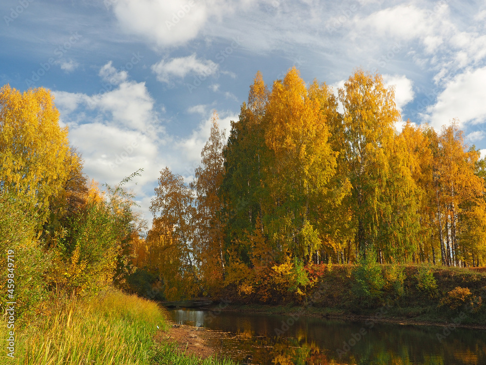 Autumn. Autumn trees in the park. River bay with floating leaves. Beautiful sky. Russia, Ural, Perm region Autumn. Autumn trees in the park. River bay with floating leaves. Beautiful sky. Russia, Ural, Perm region