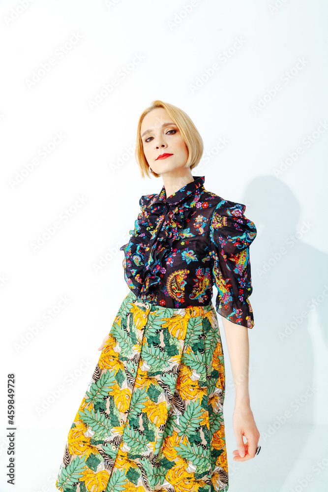 Stylish woman in bright outfit posing in photo studio Stylish woman in bright outfit posing in photo studio