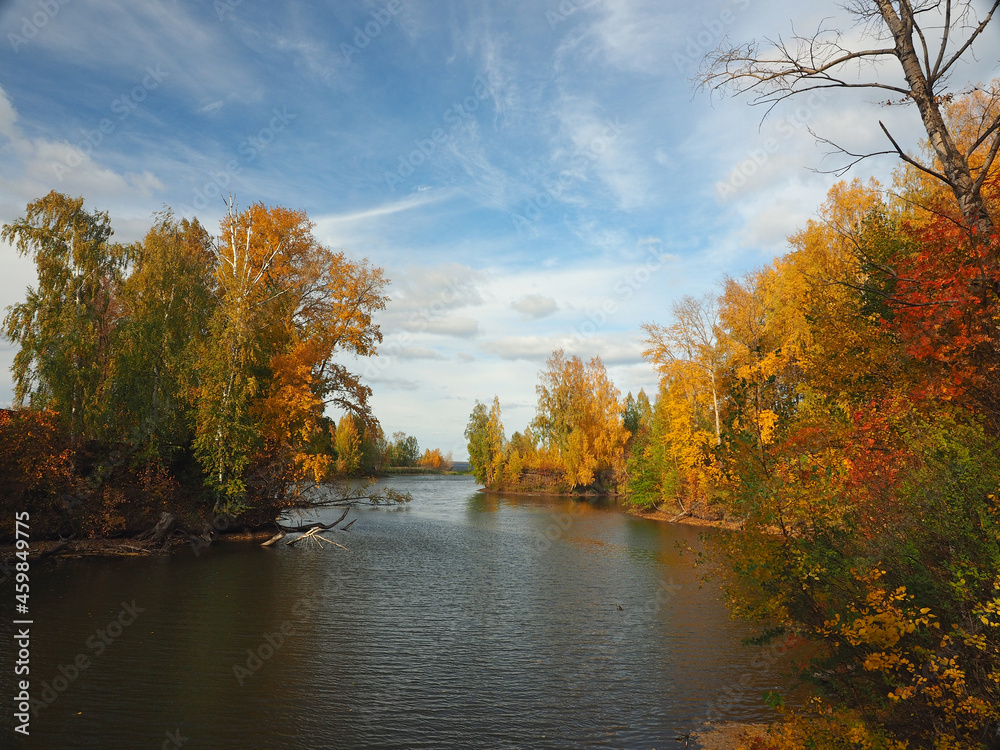 Autumn. Autumn trees in the park. River bay with floating leaves. Beautiful sky. Russia, Ural, Perm region Autumn. Autumn trees in the park. River bay with floating leaves. Beautiful sky. Russia, Ural, Perm region
