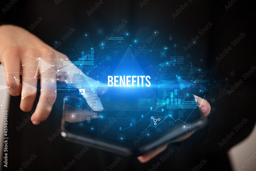 Businessman holding a foldable smartphone, business concept Businessman holding a foldable smartphone, business concept