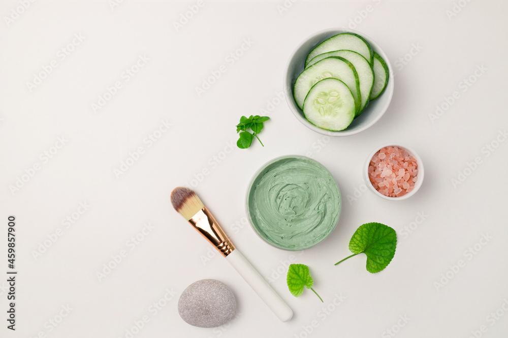 Cosmetic glass bottle, jar with nature eco cream and moisturizer tube with herbal ingredients on white surface