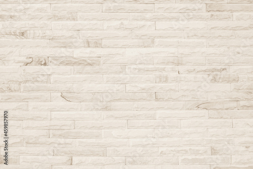 Empty background of wide cream brick wall texture. Beige old brown brick wall concrete or stone 