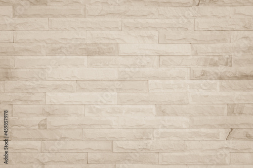 Empty background of wide cream brick wall texture. Beige old brown brick wall concrete or stone 