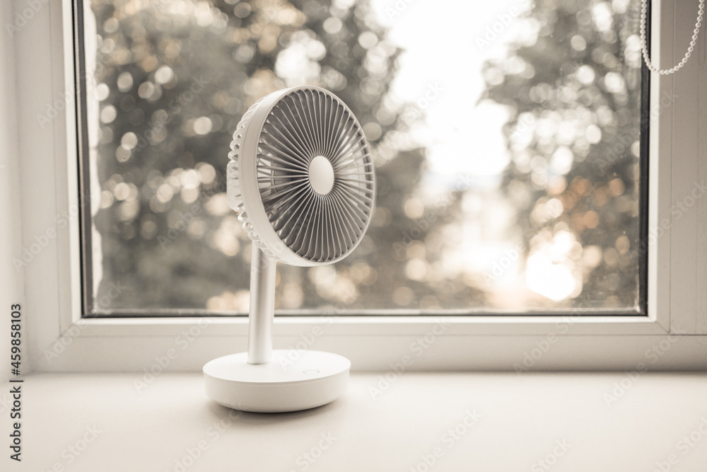 Obraz Modern electric portable fan in bedroom. Cooling of high air temperature. Minimal style, copy space. fototapeta, plakat